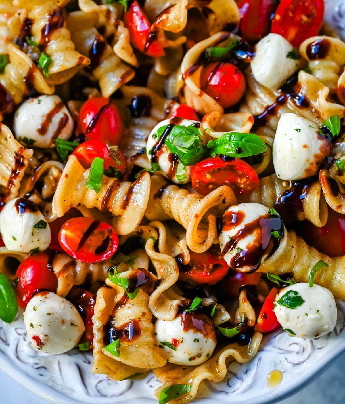 This Caprese pasta salad is a fresh, easy summer pasta salad loaded with juicy tomatoes, creamy mozzarella, and fresh basil. Tossed with olive oil and balsamic or a simple Italian dressing, it’s a light yet flavorful dish that comes together in minutes.