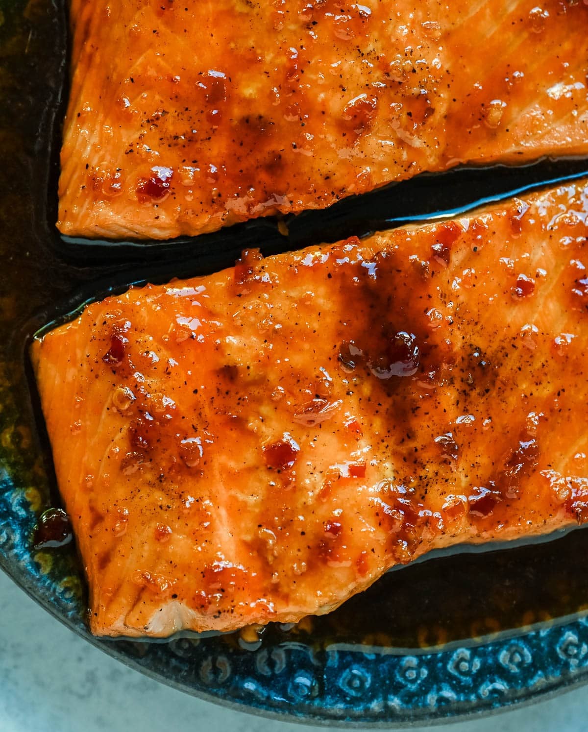 The Best Honey Garlic Glazed Salmon (Sticky, Sweet & Spicy) is the most incredible easy weeknight dinner recipe that comes together in just one pan in under 20 minutes from start to finish. Sticky sweet and garlicky, this glazed salmon recipe is hands down the most addicting salmon you will ever make coated in a rich homemade honey garlic sauce made with butter, soy sauce, fresh lemon juice, and a kick of chili garlic sauce that takes every single bite completely over the top.

