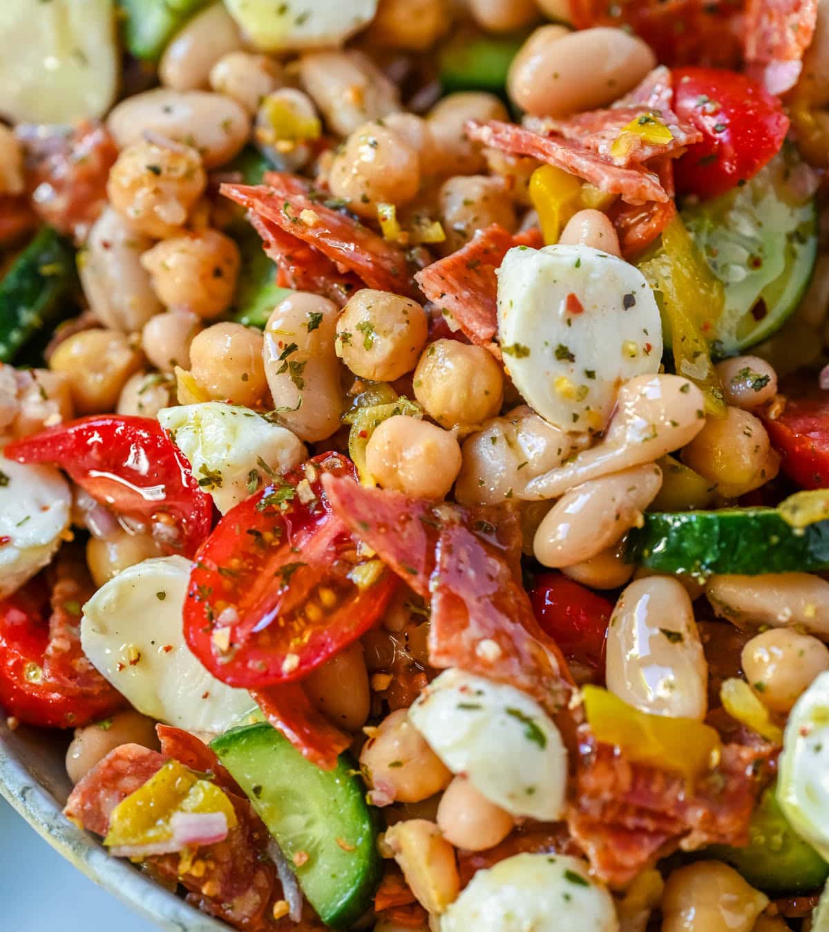 This Italian dense bean salad is the TikTok viral high protein meal prep recipe that has taken over the internet and for very good reason. Loaded with chickpeas, white beans, crisp Persian cucumbers, cherry tomatoes, creamy mozzarella, savory pepperoni or salami, and tangy pepperoncinis all tossed in a homemade Italian dressing, every single bite is packed with incredible flavor that gets better the longer it sits.