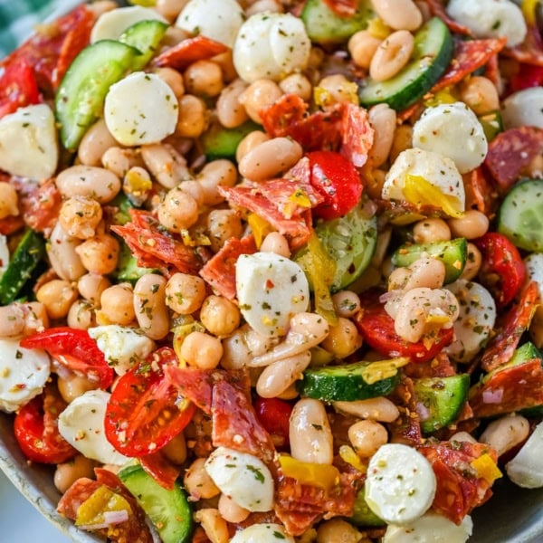 This Italian dense bean salad is the TikTok viral high protein meal prep recipe that has taken over the internet and for very good reason. Loaded with chickpeas, white beans, crisp Persian cucumbers, cherry tomatoes, creamy mozzarella, savory pepperoni or salami, and tangy pepperoncinis all tossed in a homemade Italian dressing, every single bite is packed with incredible flavor that gets better the longer it sits.