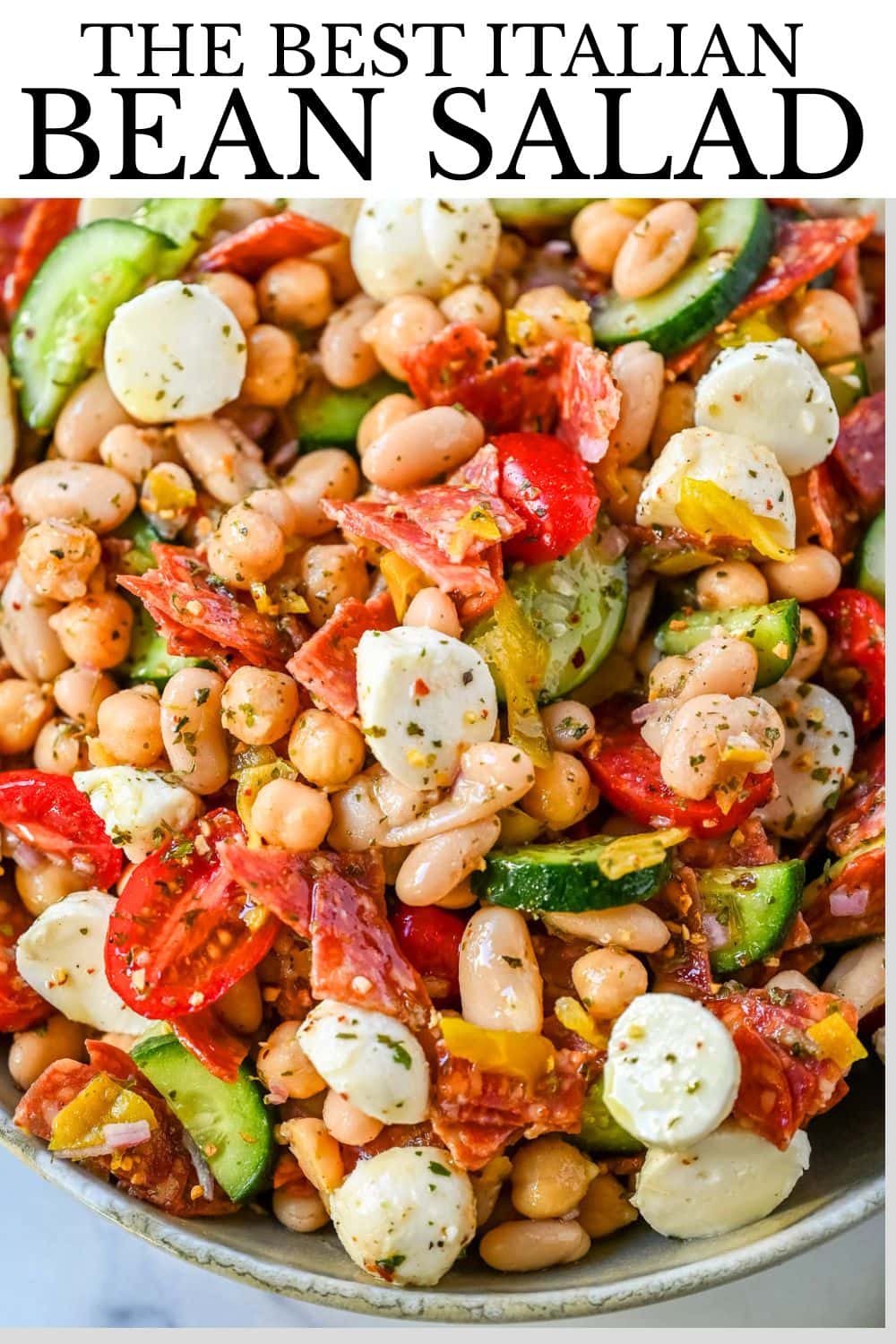 This Italian dense bean salad is the TikTok viral high protein meal prep recipe that has taken over the internet and for very good reason. Loaded with chickpeas, white beans, crisp Persian cucumbers, cherry tomatoes, creamy mozzarella, savory pepperoni or salami, and tangy pepperoncinis all tossed in a homemade Italian dressing, every single bite is packed with incredible flavor that gets better the longer it sits.