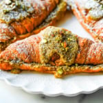 Make your own Pistachio Croissants at home in just a few easy steps! Buttery croissants are stuffed with a creamy pistachio cream filling and topped with a simple syrup and chopped pistachios for crunch. The easiest Pistachio Croissant recipe made in less than 30 minutes!