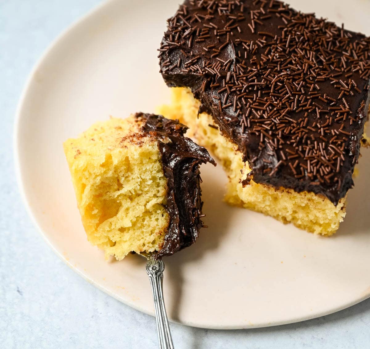 This yellow sheet cake with chocolate frosting is soft, buttery, and perfectly moist with a rich, classic flavor. The fluffy yellow sheet cake pairs beautifully with a smooth, creamy chocolate frosting that melts in every bite. The best yellow cake with chocolate frosting!