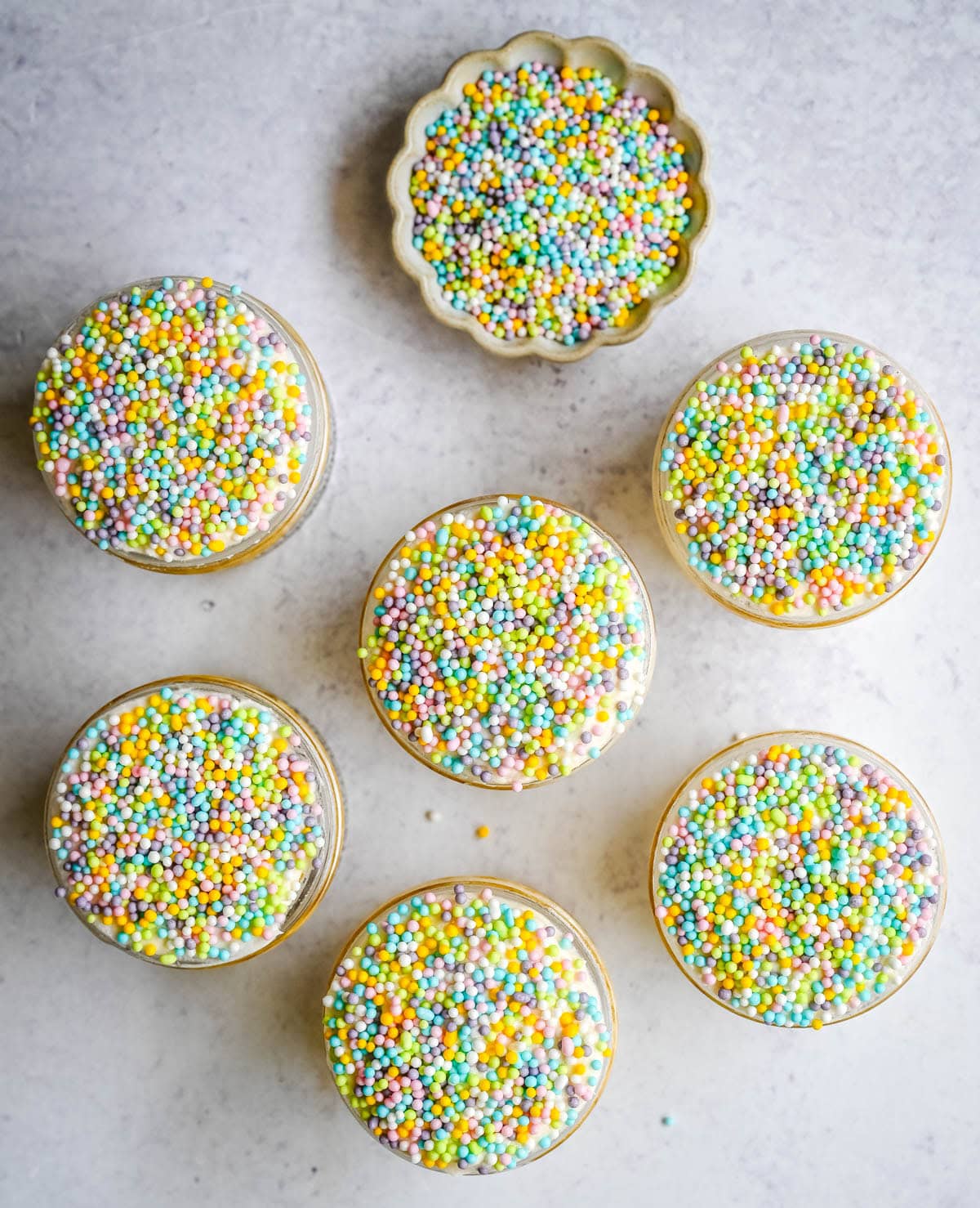 This viral dot cake recipe brings the NYC sprinkle cake trend straight to your kitchen — no trip to Butterfield Market required! Soft, buttery homemade yellow cake layered in a cup, topped with creamy vanilla buttercream, and completely coated in rainbow nonpareil sprinkles for that irresistible crunch. This easy homemade version is better than any boxed mix recipe you'll find — and takes less than an hour to make!