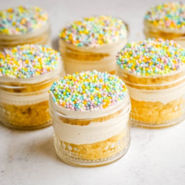 Dot Cake Recipe (Cake in a jar). This viral dot cake recipe brings the NYC sprinkle cake trend straight to your kitchen — no trip to Butterfield Market required! Soft, buttery homemade yellow cake layered in a cup, topped with creamy vanilla buttercream, and completely coated in rainbow nonpareil sprinkles for that irresistible crunch. This easy homemade version is better than any boxed mix recipe you'll find — and takes less than an hour to make!