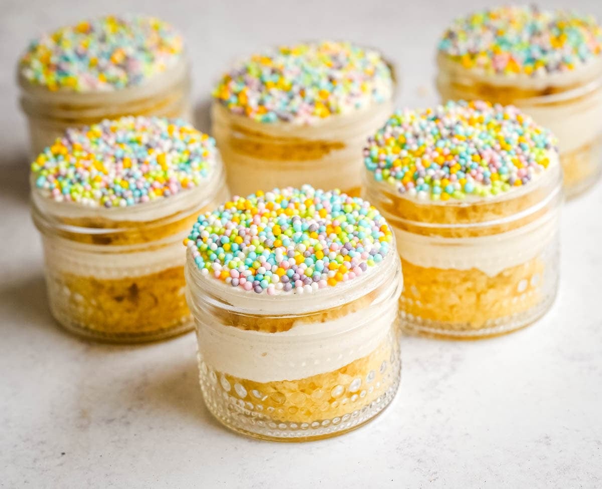 Dot Cake Recipe (Cake in a jar). This viral dot cake recipe brings the NYC sprinkle cake trend straight to your kitchen — no trip to Butterfield Market required! Soft, buttery homemade yellow cake layered in a cup, topped with creamy vanilla buttercream, and completely coated in rainbow nonpareil sprinkles for that irresistible crunch. This easy homemade version is better than any boxed mix recipe you'll find — and takes less than an hour to make!