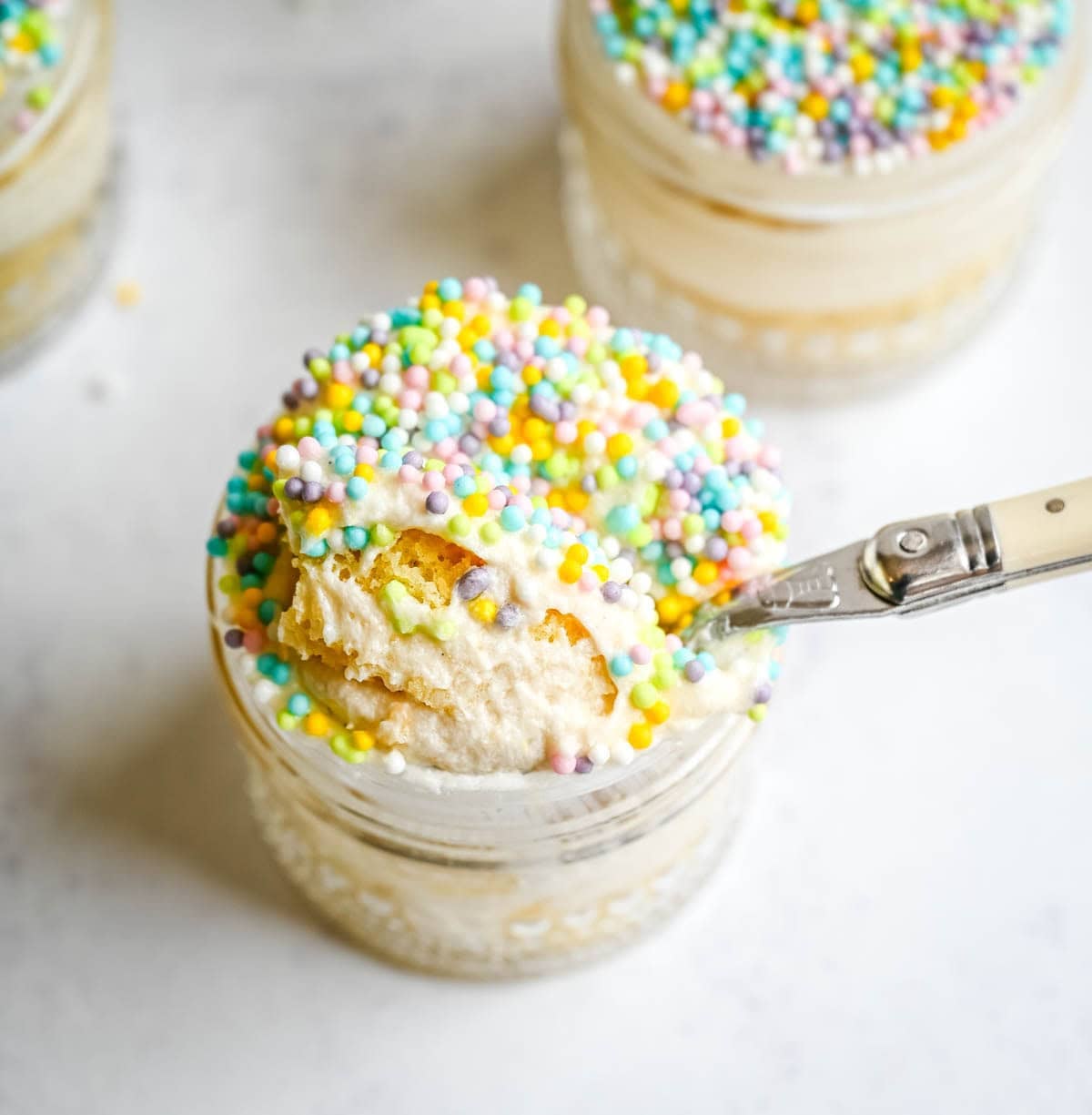 Dot Cake Recipe (Cake in a jar). This viral dot cake recipe brings the NYC sprinkle cake trend straight to your kitchen — no trip to Butterfield Market required! Soft, buttery homemade yellow cake layered in a cup, topped with creamy vanilla buttercream, and completely coated in rainbow nonpareil sprinkles for that irresistible crunch. This easy homemade version is better than any boxed mix recipe you'll find — and takes less than an hour to make!