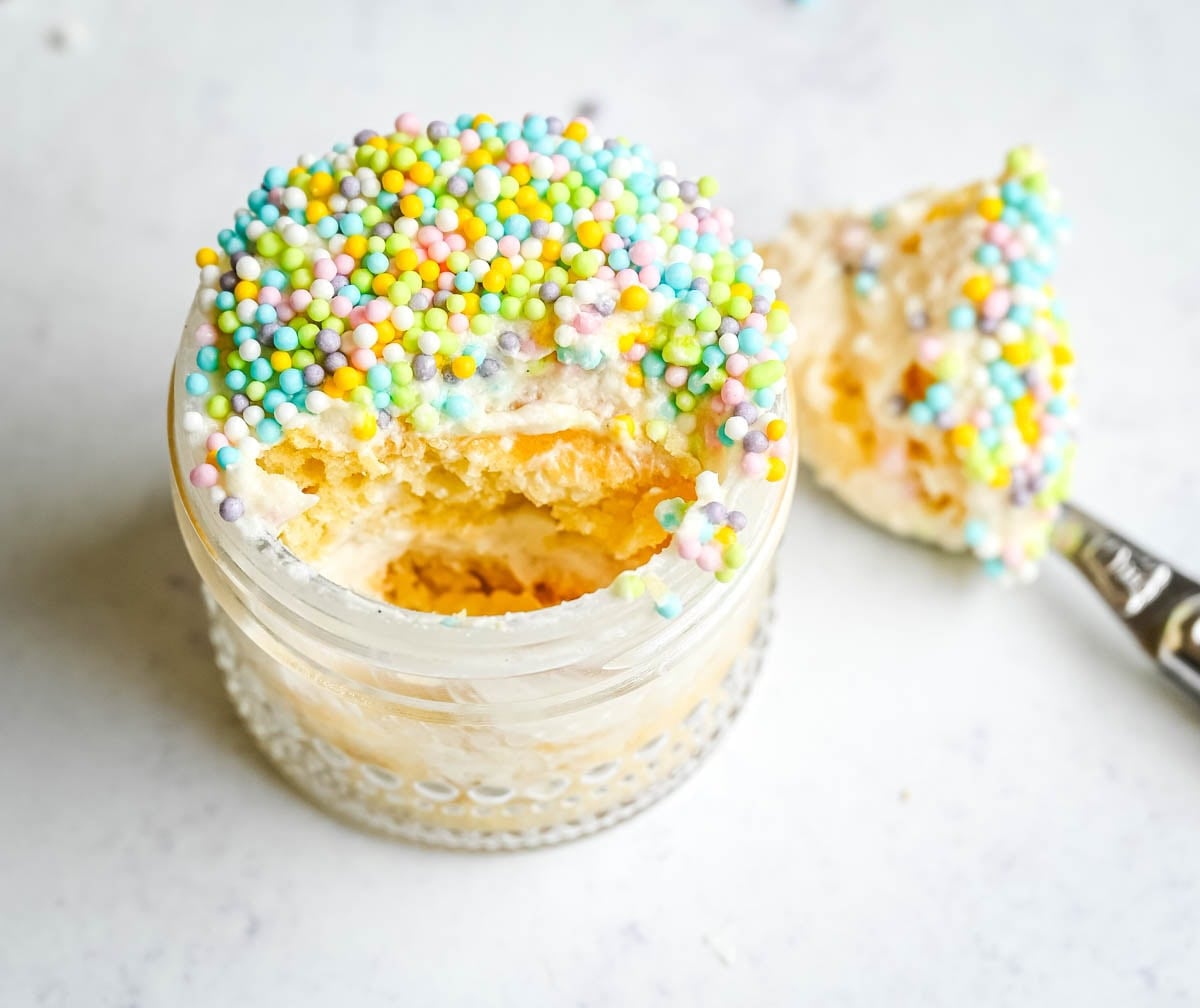 This viral dot cake recipe brings the NYC sprinkle cake trend straight to your kitchen — no trip to Butterfield Market required! Soft, buttery homemade yellow cake layered in a cup, topped with creamy vanilla buttercream, and completely coated in rainbow nonpareil sprinkles for that irresistible crunch. This easy homemade version is better than any boxed mix recipe you'll find — and takes less than an hour to make!