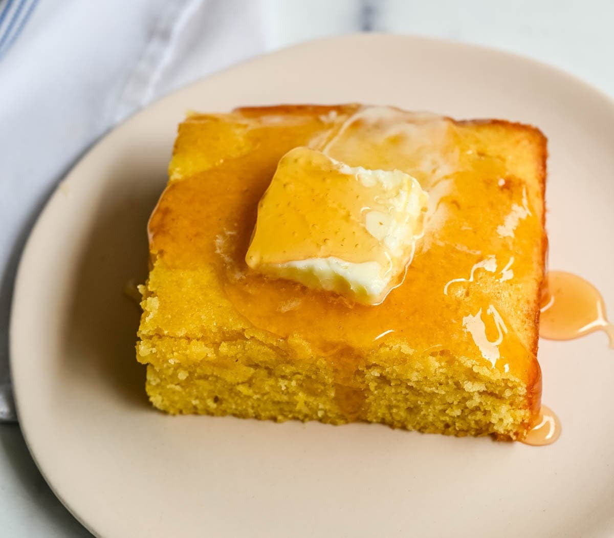 This moist and fluffy hot honey cornbread is sweet, slightly spicy, and absolutely packed with flavor from the very first bite! This is the most irresistible cornbread topped with hot honey butter you will ever make, and it comes together in just one bowl in under 30 minutes, making it the easiest and most flavorful side dish.