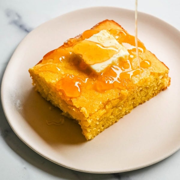 This moist and fluffy hot honey cornbread is sweet, slightly spicy, and absolutely packed with flavor from the very first bite! This is the most irresistible cornbread topped with hot honey butter you will ever make, and it comes together in just one bowl in under 30 minutes, making it the easiest and most flavorful side dish.