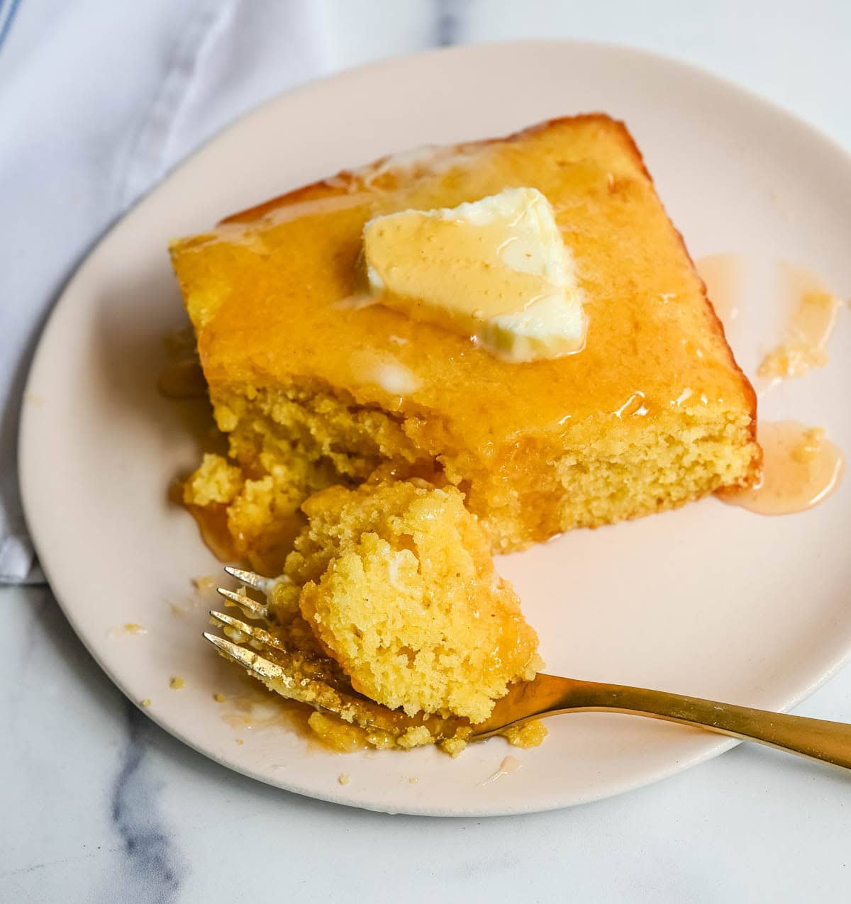 This moist and fluffy hot honey cornbread is sweet, slightly spicy, and absolutely packed with flavor from the very first bite! This is the most irresistible cornbread topped with hot honey butter you will ever make, and it comes together in just one bowl in under 30 minutes, making it the easiest and most flavorful side dish.