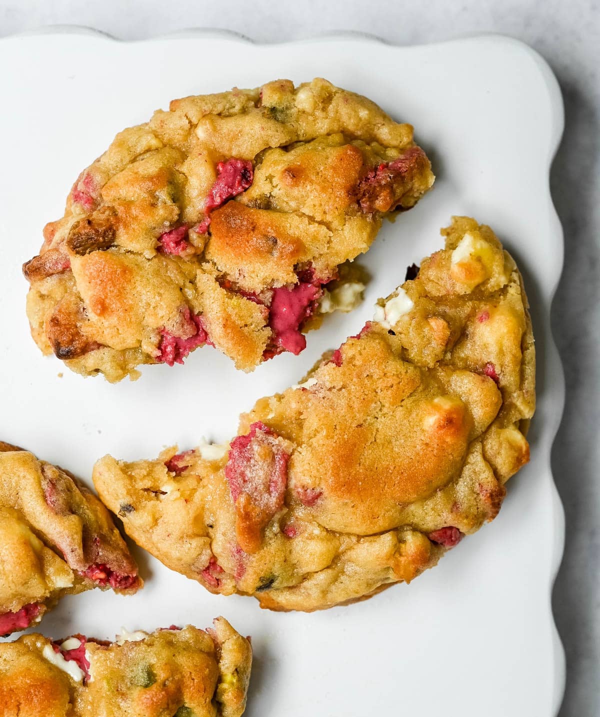 These Levain Bakery Raspberry Pistachio cookies are a homemade copycat of Levain Bakery's new summer flavor, which combines raspberry chips, crunchy pistachios, and creamy white chocolate chips in their signature thick, bakery-style cookie. Our version uses a homemade raspberry chip made from crushed freeze-dried raspberries and white chocolate for that same fruity flavor without needing specialty baking chips. These cookies are thick, gooey, and loaded with tart raspberry, rich white chocolate, and crunchy salted pistachios in every bite!
