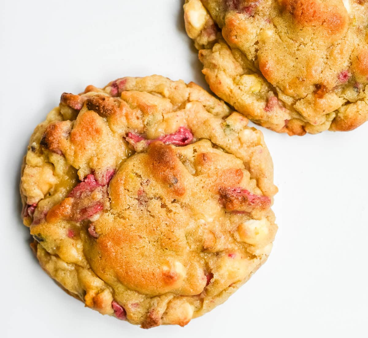 These Levain Bakery Raspberry Pistachio cookies are a homemade copycat of Levain Bakery's new summer flavor, which combines raspberry chips, crunchy pistachios, and creamy white chocolate chips in their signature thick, bakery-style cookie. Our version uses a homemade raspberry chip made from crushed freeze-dried raspberries and white chocolate for that same fruity flavor without needing specialty baking chips. These cookies are thick, gooey, and loaded with tart raspberry, rich white chocolate, and crunchy salted pistachios in every bite!