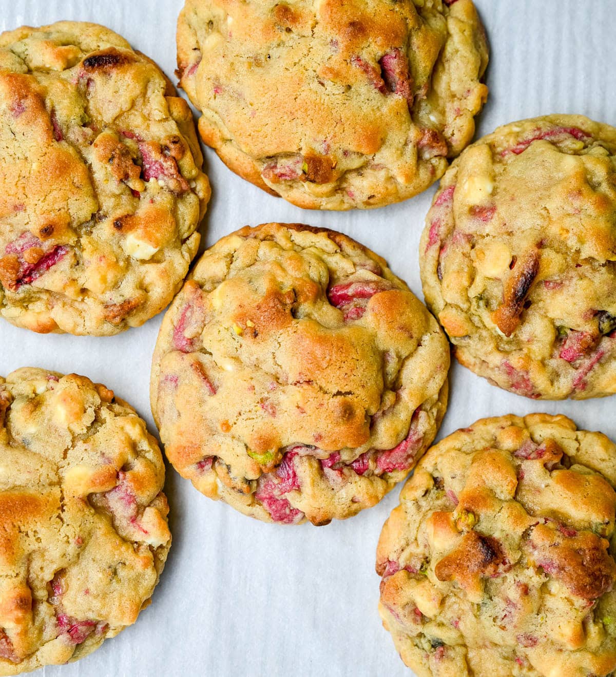 These Levain Bakery Raspberry Pistachio cookies are a homemade copycat of Levain Bakery's new summer flavor, which combines raspberry chips, crunchy pistachios, and creamy white chocolate chips in their signature thick, bakery-style cookie. Our version uses a homemade raspberry chip made from crushed freeze-dried raspberries and white chocolate for that same fruity flavor without needing specialty baking chips. These cookies are thick, gooey, and loaded with tart raspberry, rich white chocolate, and crunchy salted pistachios in every bite!