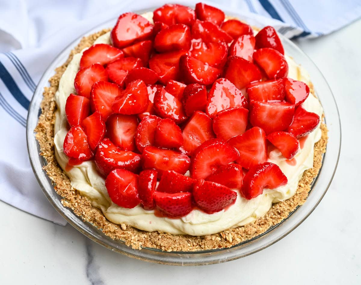 This strawberry pretzel pie has no Jello — just a buttery pretzel crust, fluffy no-bake cream cheese filling, and fresh sweet strawberries for the ultimate no-bake summer dessert that's as easy as it is show-stopping.