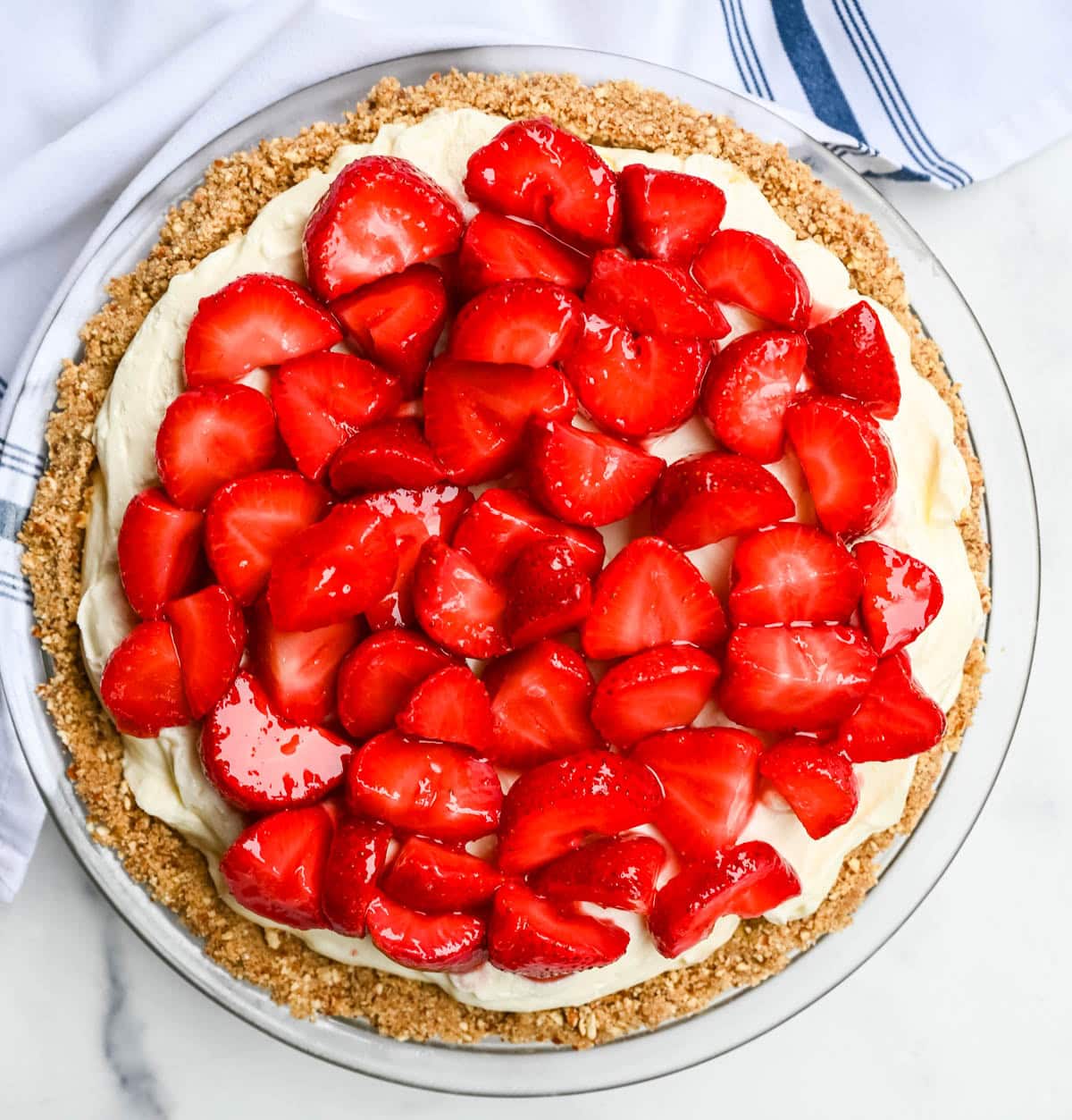 This strawberry pretzel pie has no Jello — just a buttery pretzel crust, fluffy no-bake cream cheese filling, and fresh sweet strawberries for the ultimate no-bake summer dessert that's as easy as it is show-stopping.