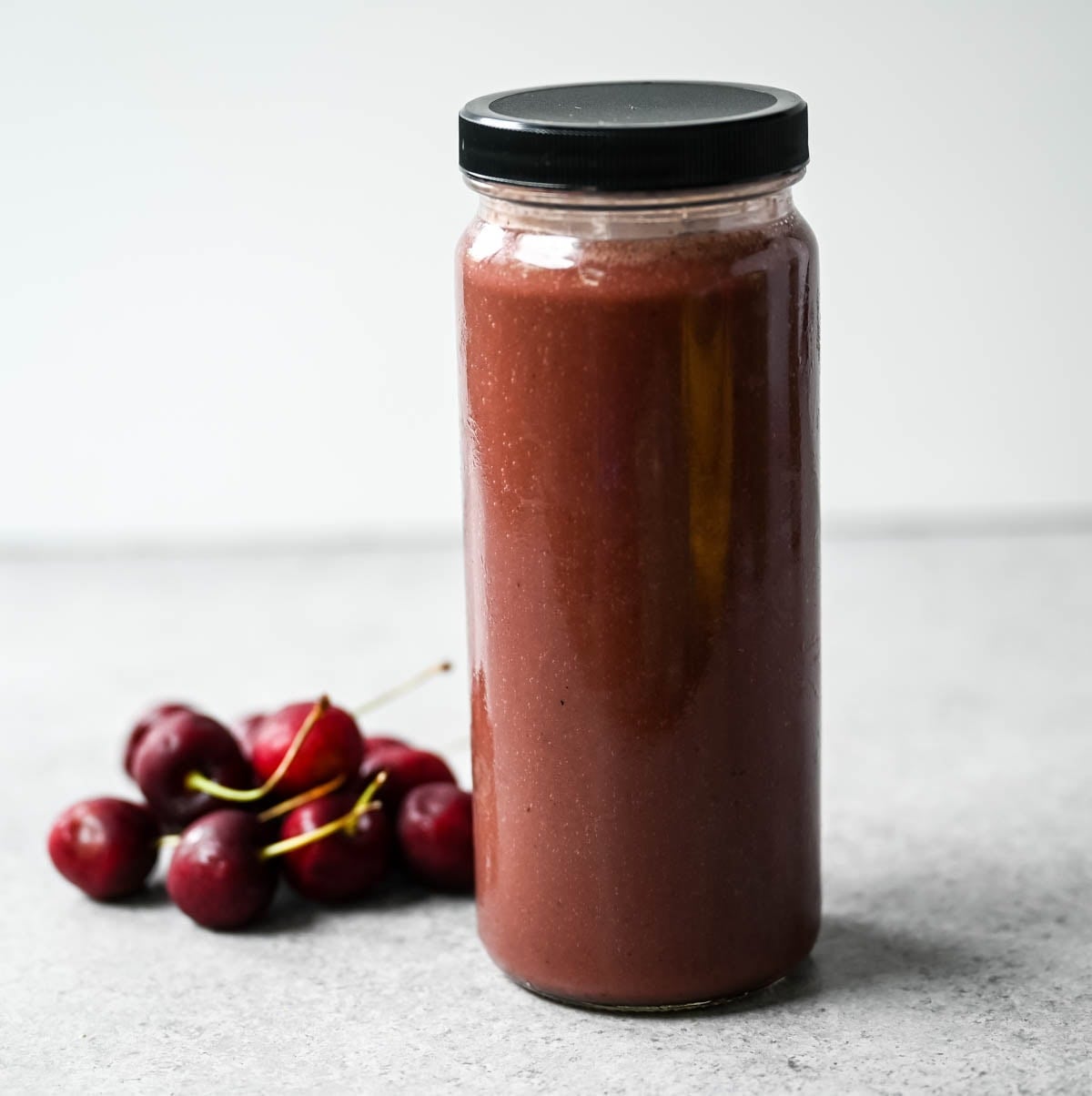 Rich, slightly nutty, and dessert-like, this cherry almond smoothie is packed with protein — a great post-workout recovery drink or afternoon pick-me-up. Cherry almond protein smoothie topped with coconut flakes and almond butter
