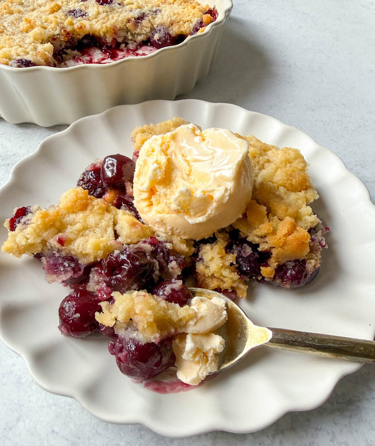 Want to make cherry cobbler with fresh cherries? This recipe combines a jammy cherry filling with a golden sugar cookie topping for the perfect summer dessert.