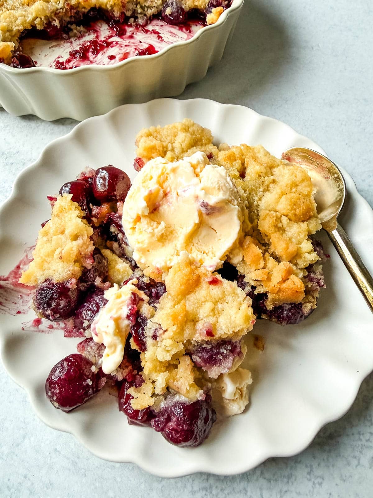 Want to make cherry cobbler with fresh cherries? This recipe combines a jammy cherry filling with a golden sugar cookie topping for the perfect summer dessert.