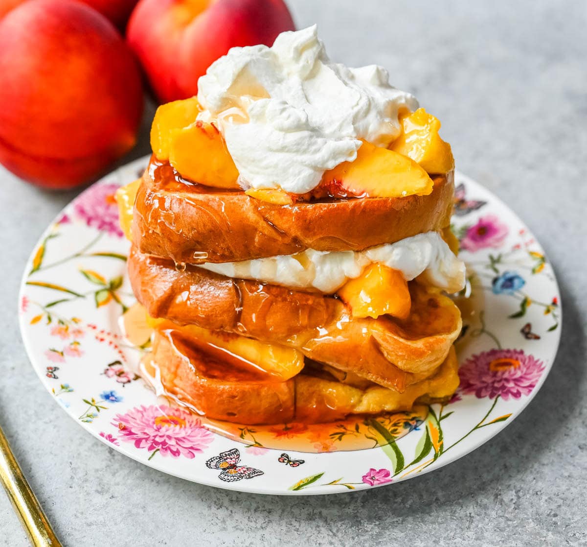 This Peaches and Cream French toast is made with thick slices of challah or brioche bread soaked in a rich, creamy custard, then topped with fresh whipped cream, juicy peaches, and real maple syrup. It's the ultimate easy peach French toast recipe.
