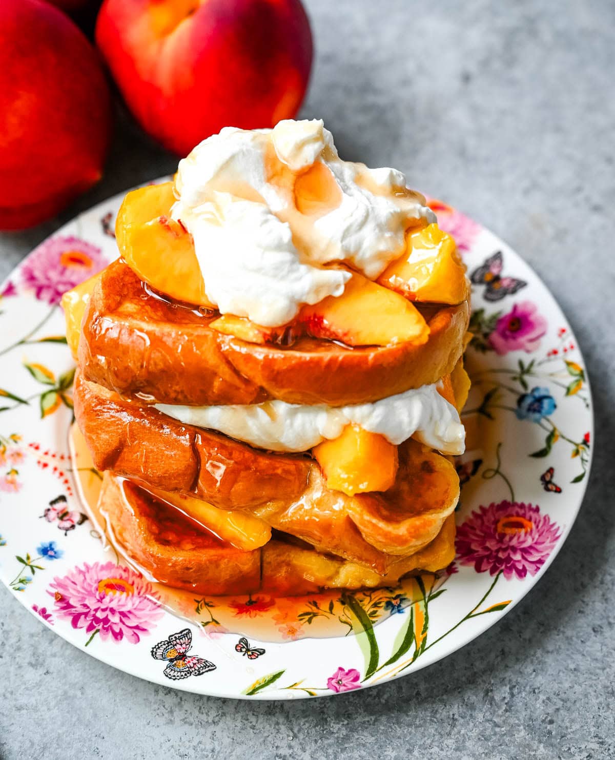 This Peaches and Cream French toast is made with thick slices of challah or brioche bread soaked in a rich, creamy custard, then topped with fresh whipped cream, juicy peaches, and real maple syrup. It's the ultimate easy peach French toast recipe.