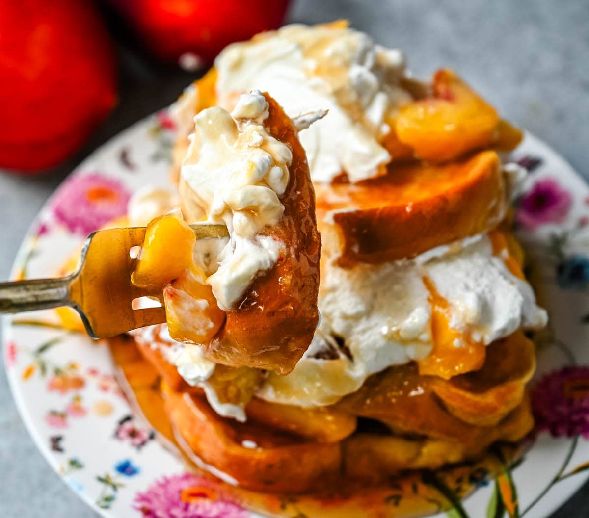 This Peaches and Cream French toast is made with thick slices of challah or brioche bread soaked in a rich, creamy custard, then topped with fresh whipped cream, juicy peaches, and real maple syrup. It's the ultimate easy peach French toast recipe.