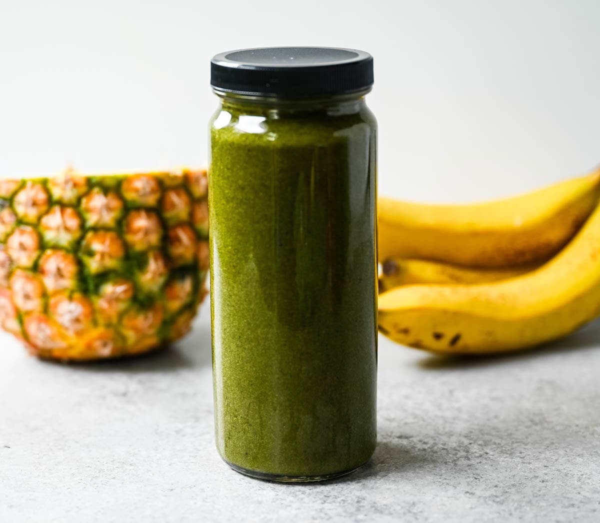 Sweet pineapple and juicy grapes make this one of the easiest ways to sneak greens into your morning without tasting them. Tropical green smoothie with pineapple, spinach, and grapes