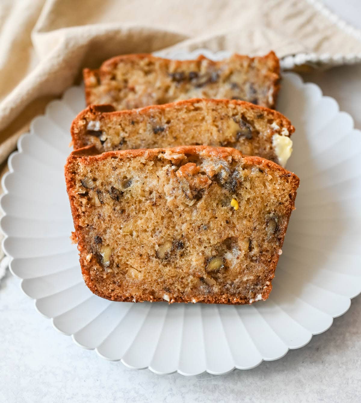 Best Banana Nut Bread Recipe. This is the moistest banana nut bread you'll ever make — a rich, tender loaf made with ripe bananas, sour cream, and your choice of walnuts, pecans, or macadamia nuts. Includes tips for the ultimate moist crumb, a brown sugar topping, and answers to every banana bread question you have.