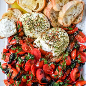This Burrata Tomato Salad is made with creamy burrata, juicy tomatoes, fresh basil, and a balsamic drizzle — this 10-minute Burrata Caprese Salad is the easiest no-cook summer appetizer.