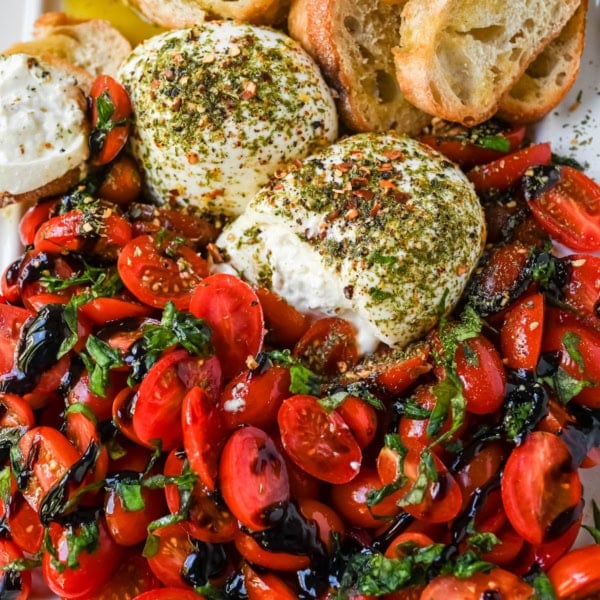 This Burrata Tomato Salad is made with creamy burrata, juicy tomatoes, fresh basil, and a balsamic drizzle — this 10-minute Burrata Caprese Salad is the easiest no-cook summer appetizer.