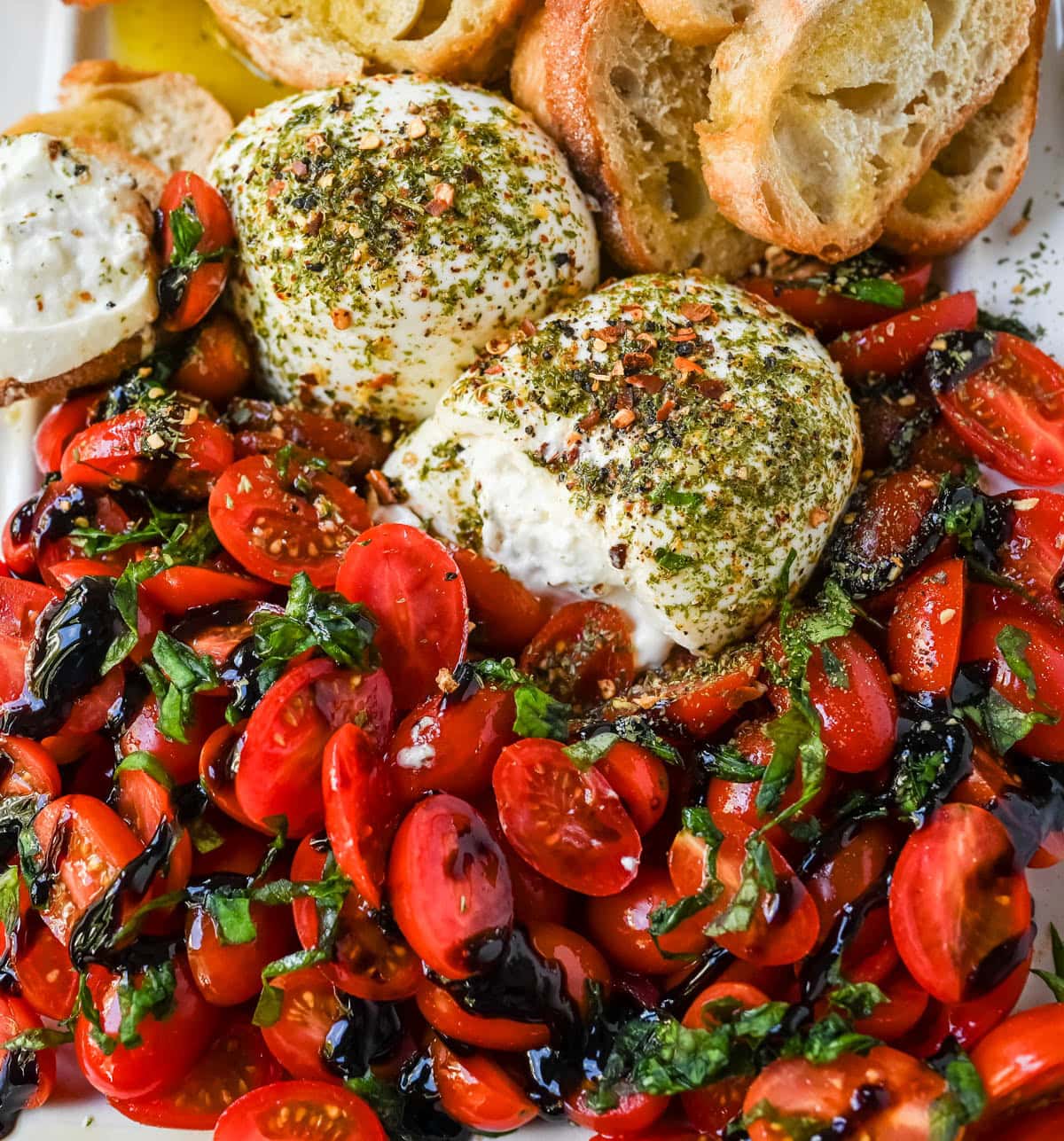 This Burrata Tomato Salad is made with creamy burrata, juicy tomatoes, fresh basil, and a balsamic drizzle — this 10-minute Burrata Caprese Salad is the easiest no-cook summer appetizer.