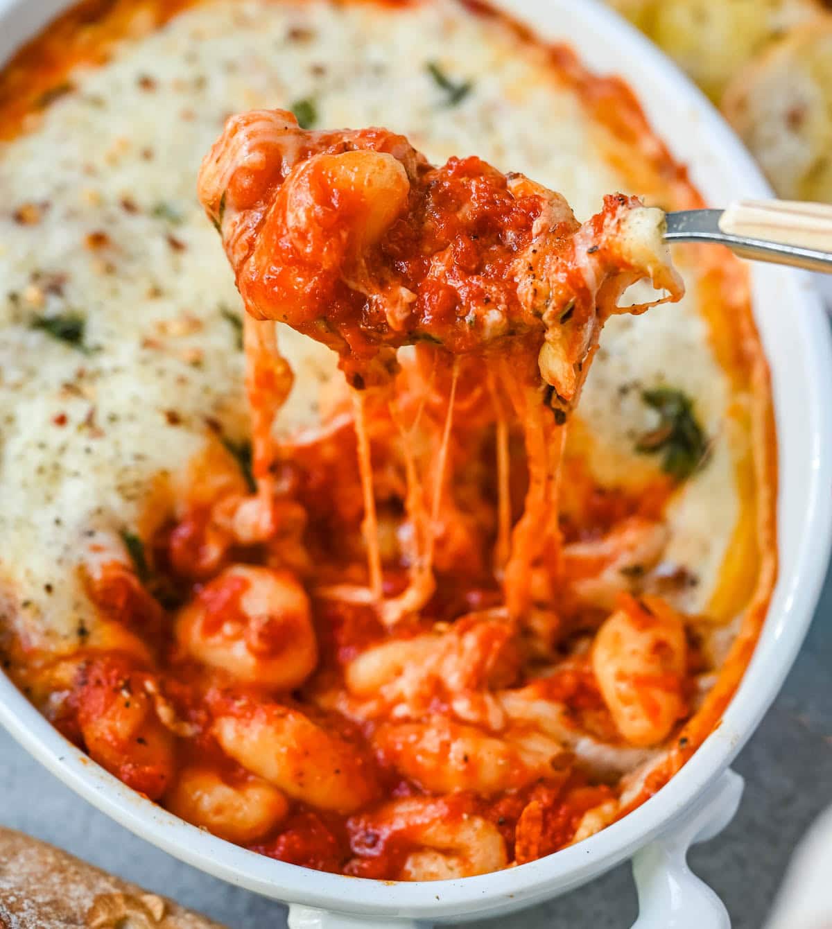 This cheesy baked gnocchi is made with pillowy gnocchi tossed in marinara sauce, layered with mozzarella and parmesan, and baked until golden and bubbly. Topped with fresh basil, this easy gnocchi bake comes together in one dish and tastes like it took hours.