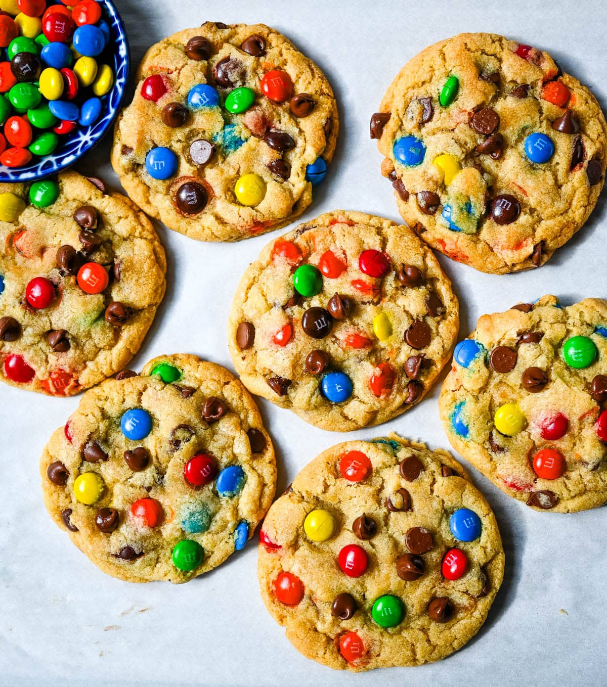 These M&M chocolate chip cookies have crisp, buttery edges and soft, chewy centers, loaded with both M&M's and semi-sweet chocolate chips. No mixer required — just mix in a bowl, chill, and bake for the best chocolate chip M&M cookies!
