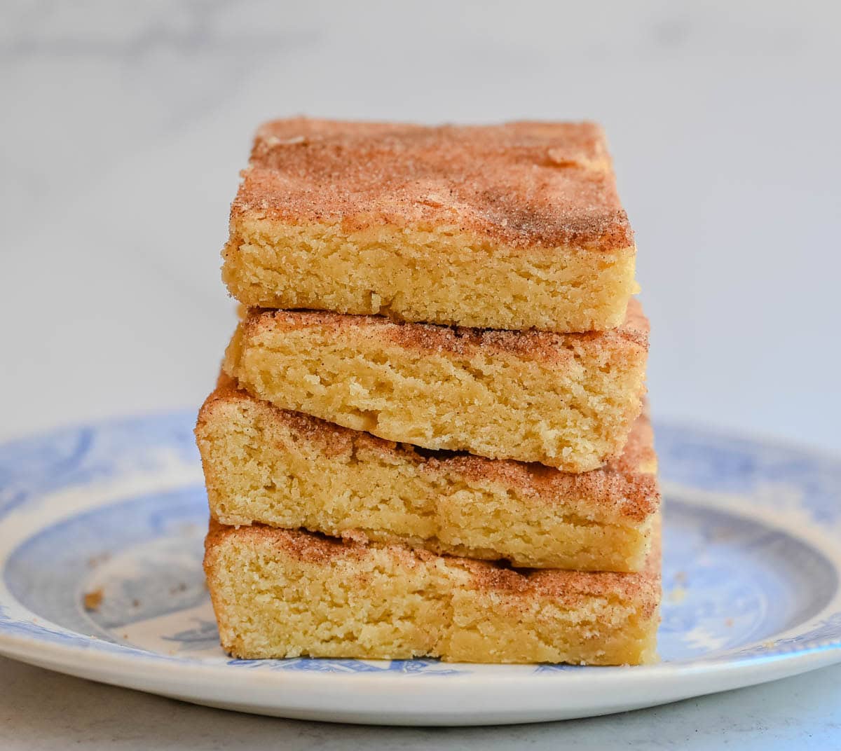 These snickerdoodle bars have all the soft, chewy, cinnamon-sugar flavor of classic snickerdoodle cookies, baked in one pan for an easier, faster version. No scooping, no rolling — just press, sprinkle, and bake for a crowd-sized batch of snickerdoodle flavor in every bite.