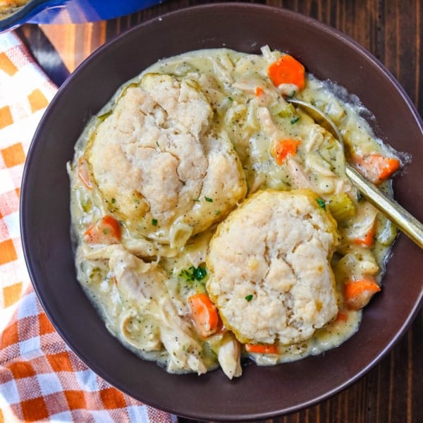 This homemade chicken cobbler is the from-scratch version of the viral casserole everyone has been making, with a rich, creamy chicken filling and buttery cheddar garlic drop biscuits baked right on top. No boxed biscuit mix. No canned cream of chicken soup. Just real ingredients and a one-pan dinner that tastes like you spent all afternoon on it.