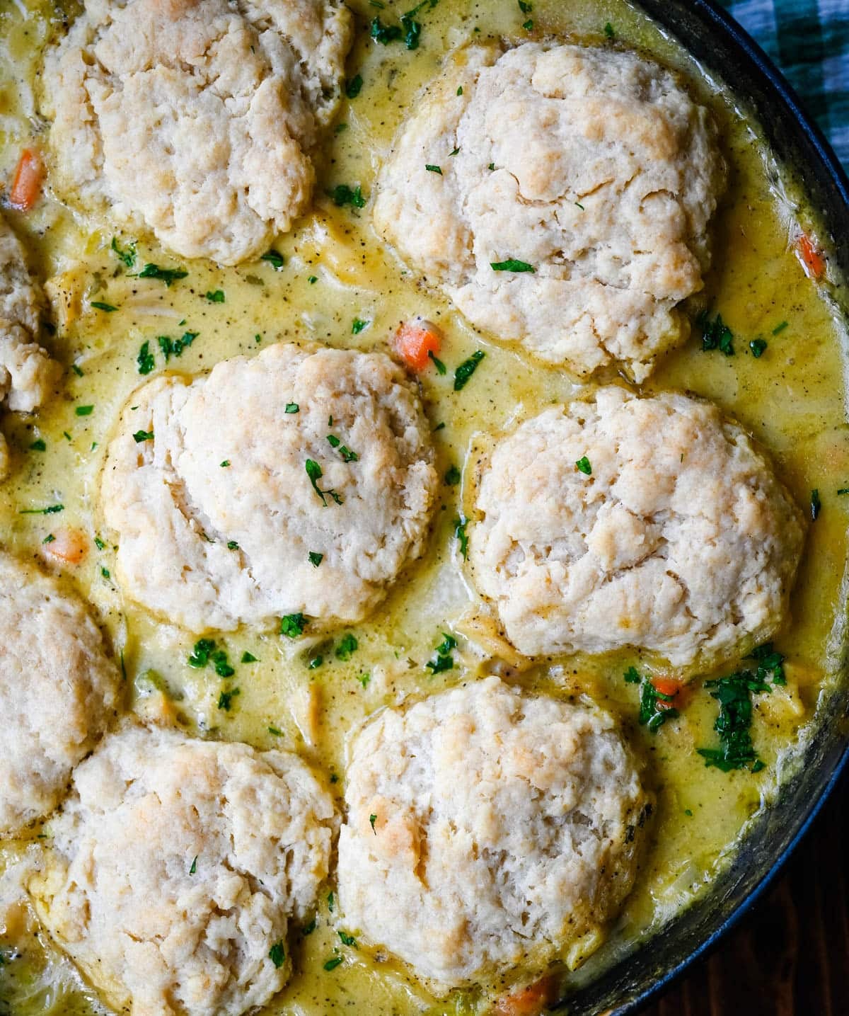 This homemade chicken cobbler is the from-scratch version of the viral casserole everyone has been making, with a rich, creamy chicken filling and buttery cheddar garlic drop biscuits baked right on top. No boxed biscuit mix. No canned cream of chicken soup. Just real ingredients and a one-pan dinner that tastes like you spent all afternoon on it.
