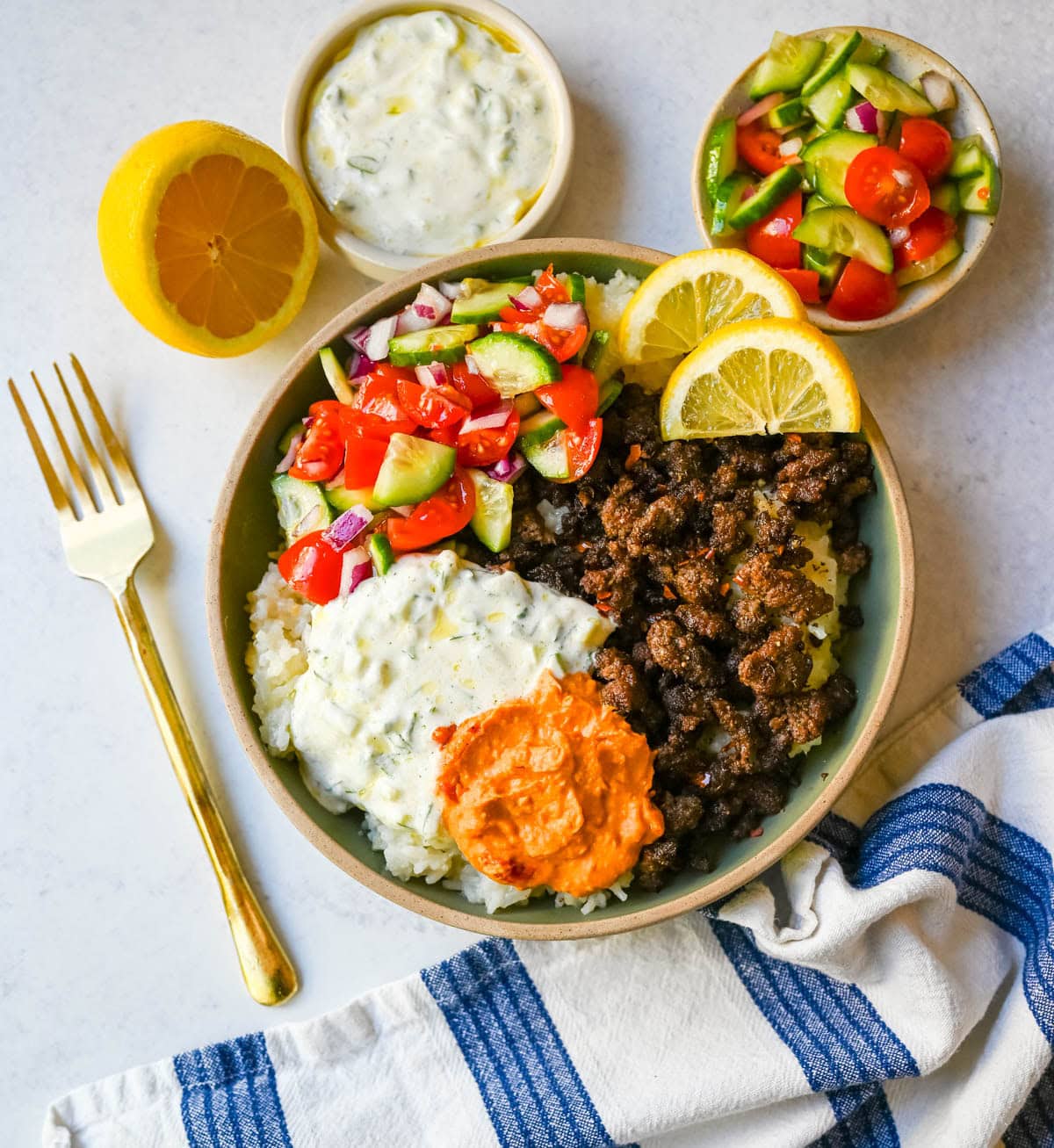 Greek Beef Bowls. Juicy seasoned ground beef, bright lemon rice, feta, cucumbers, tomatoes and tzatziki in one easy 35-minute dinner. High-protein bowls that hold up all week for lunches.