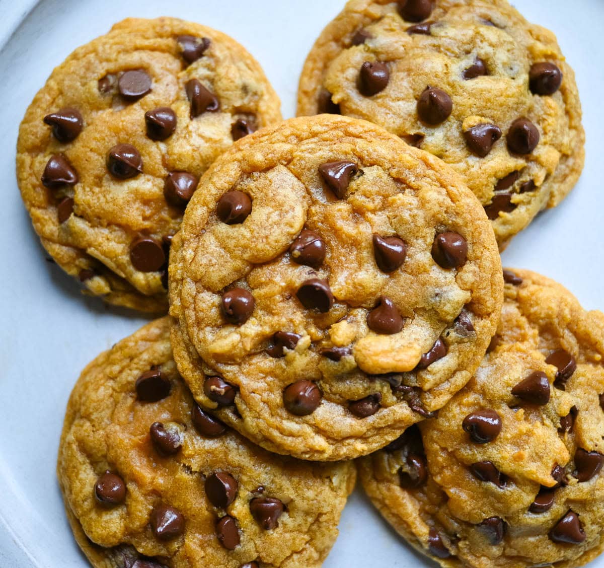These pumpkin chocolate chip cookies are soft, chewy, and loaded with melty chocolate, with none of the cakey, muffin-top texture most pumpkin cookies have. Brown butter gives them a deep toffee-caramel flavor, and one simple trick with the pumpkin purée is what keeps them chewy instead of puffy.