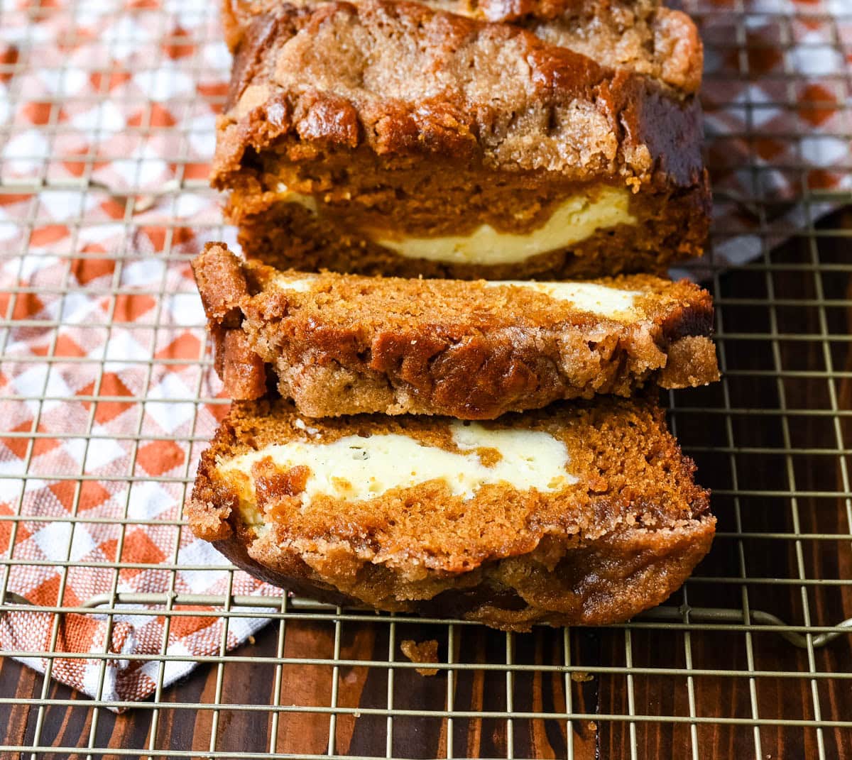 This pumpkin cream cheese bread has a thick ribbon of tangy cheesecake running through the middle, a buttery brown sugar streusel on top, and one simple trick that gives it the deepest, richest pumpkin flavor you've had in a loaf. This is the best pumpkin cream cheese bread recipe and it makes two loaves.