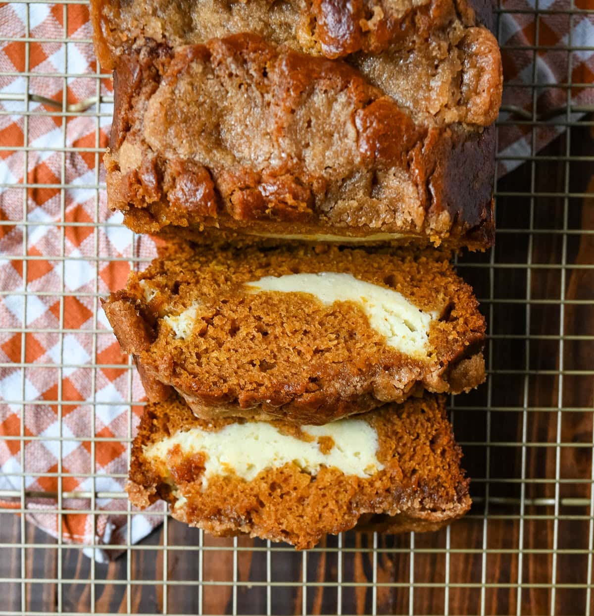 This pumpkin cream cheese bread has a thick ribbon of tangy cheesecake running through the middle, a buttery brown sugar streusel on top, and one simple trick that gives it the deepest, richest pumpkin flavor you've had in a loaf. This is the best pumpkin cream cheese bread recipe and it makes two loaves.