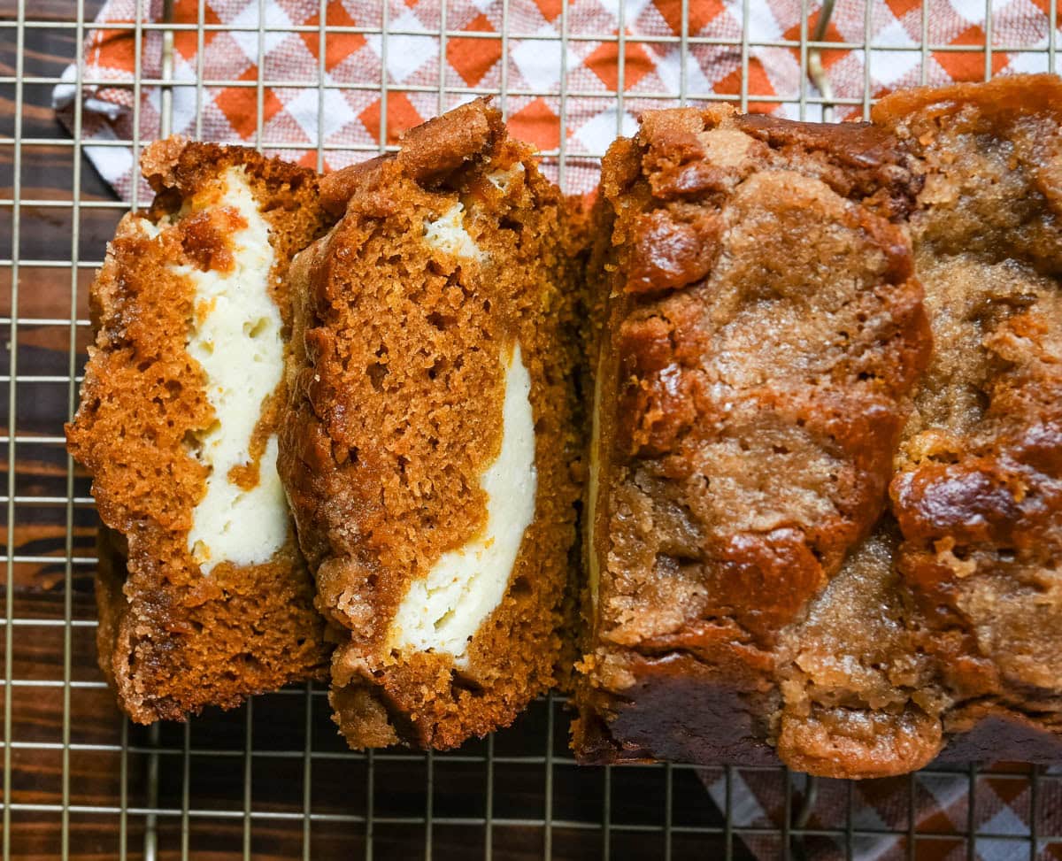 This pumpkin cream cheese bread has a thick ribbon of tangy cheesecake running through the middle, a buttery brown sugar streusel on top, and one simple trick that gives it the deepest, richest pumpkin flavor you've had in a loaf. This is the best pumpkin cream cheese bread recipe and it makes two loaves.