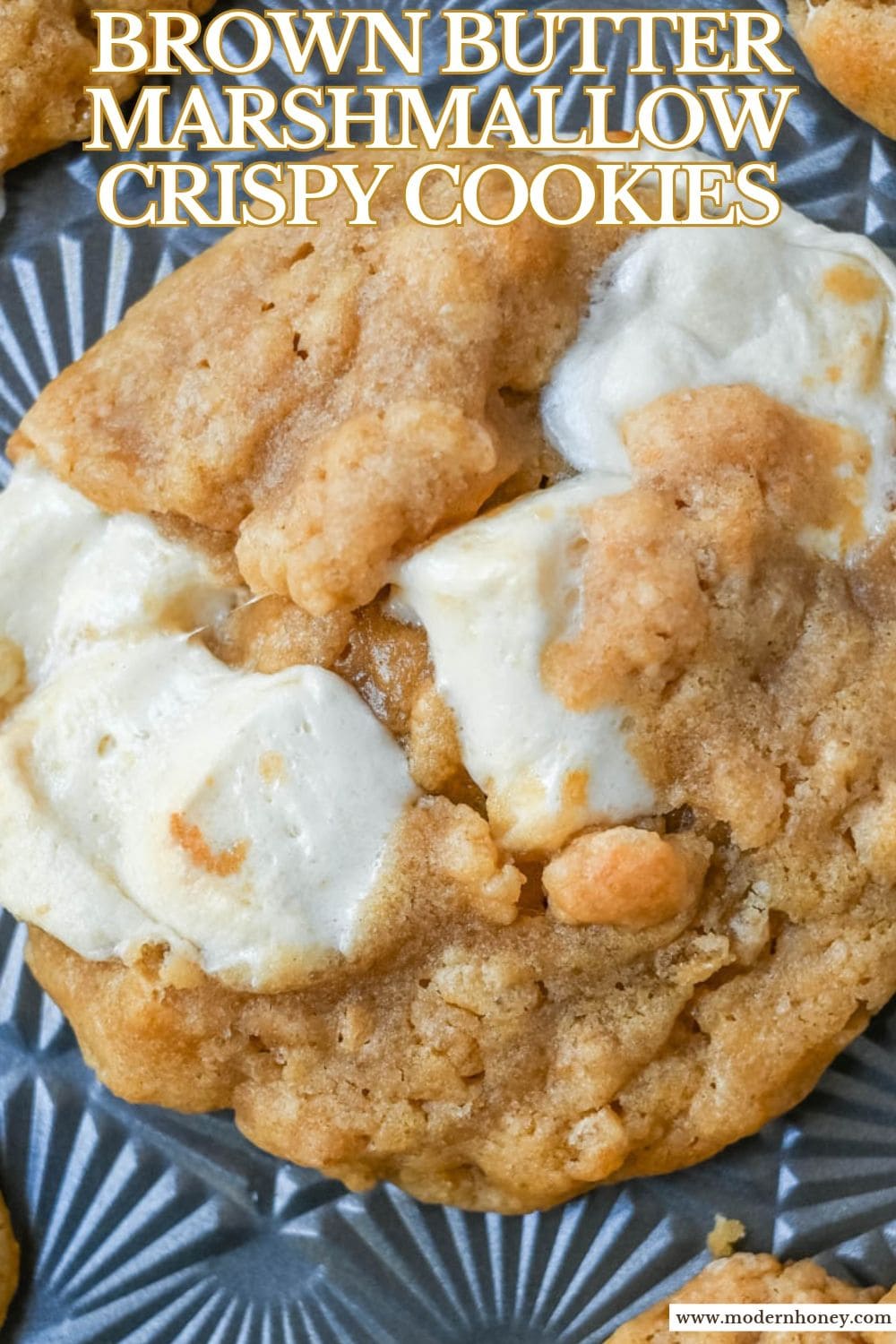 Marshmallow Crispy Cookies taste like a Rice Krispie treat in cookie form! This Costco Marshmallow Crispy Cookie copycat is made with nutty brown butter, gooey marshmallows, crispy rice cereal, and a sprinkle of flaky salt. They’re big, bakery-style cookies with crisp golden edges and soft, chewy centers, and they’re even better warm from your own oven. Perfect for bake sales, lunch boxes, and holiday cookie trays. Save this easy brown butter Rice Krispie treat cookie recipe for your next batch!