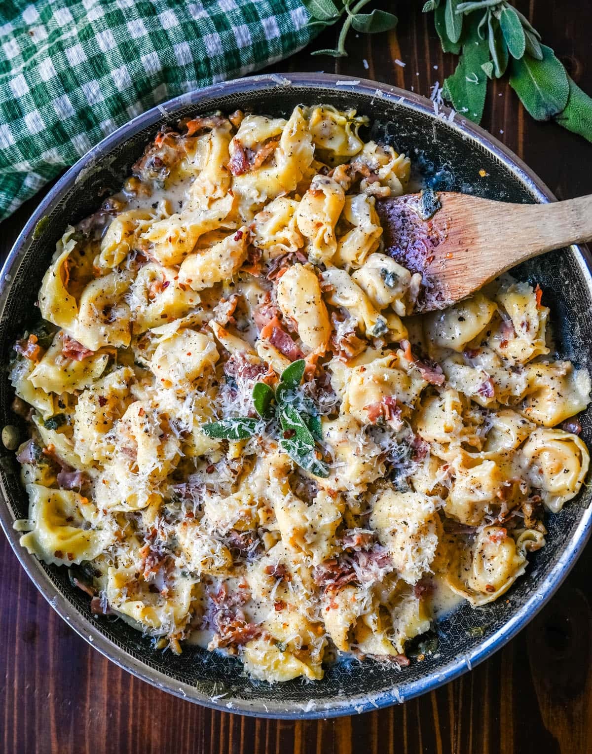 Brown Butter Tortellini with creamy parmesan cheese sauce, crispy prosciutto, sage, all tossed wtih cheese tortellini in a skillet.