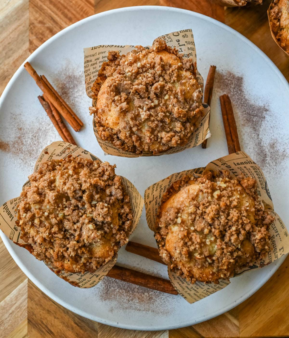 Coffee Cake Muffins with streusel on top and in the middle on a plate.