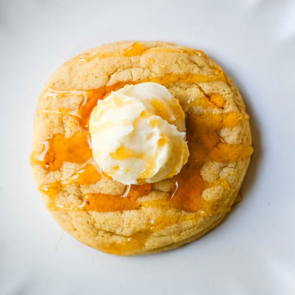 Turn your favorite cornbread into a cookie! These soft cornbread cookies have crisp golden edges, a tender cornmeal crumb, and whipped honey butter on top. Better than Crumbl!