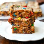 These Monster Cookie Bars take my most popular monster cookie recipe and turn it into an easy, no-scoop dessert you bake right in a 9x13 pan. They’re thick and chewy peanut butter oatmeal bars loaded with M&M’s and chocolate chips, with crisp golden edges and a soft, gooey center. If you love monster cookies but don’t want to scoop and bake batch after batch, these monster bars are for you. They are made in one bowl and feed a crowd.