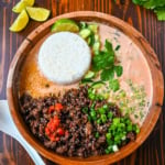 This Red Curry Beef Broth Bowl recipe is an easy weeknight dinner loaded with crispy, glazed ground beef, a creamy coconut red curry broth then topped with fresh herbs, cucumber, and sesame seeds. This easy 30-minute recipe is packed with flavor and comes together faster than takeout.