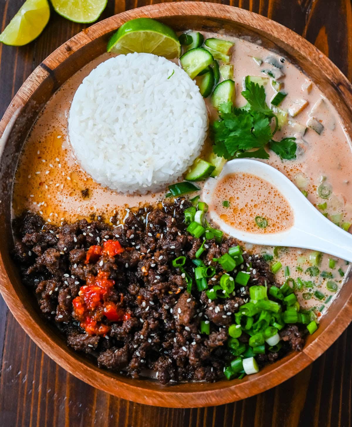 This Red Curry Beef Broth Bowl recipe is an easy weeknight dinner loaded with crispy, glazed ground beef, a creamy coconut red curry broth then topped with fresh herbs, cucumber, and sesame seeds. This easy 30-minute recipe is packed with flavor and comes together faster than takeout.