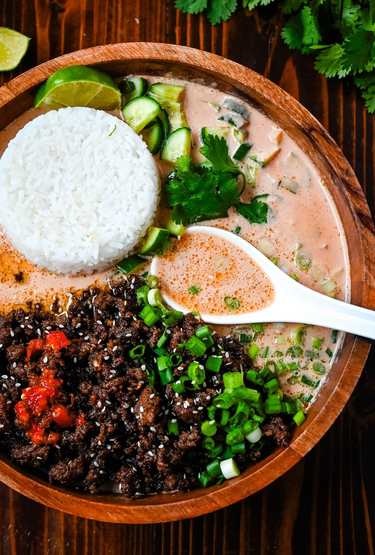 Red Curry Beef Broth Bowls in a bowl with a spoon. TikTok viral beef broth bowls recipe.