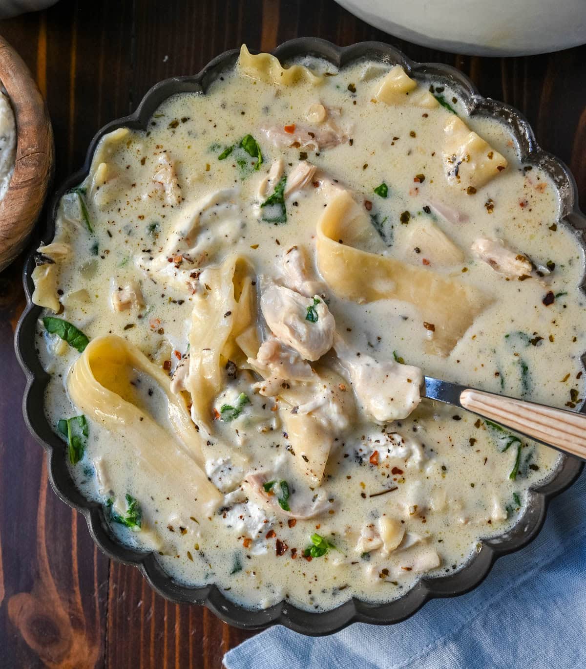 This White Chicken Lasagna Soup is everything you love about a creamy, cheesy chicken lasagna, without all the layering! Lasagna noodles, tender shredded chicken, and spinach all simmer together in one pot in a garlicky parmesan cream broth. Then you top each bowl with a dollop of herbed ricotta that melts right in. It's cozy comfort food at its easiest, and it's on the table in about 40 minutes.